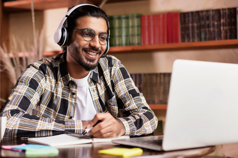 Student wearing headphones attending online class